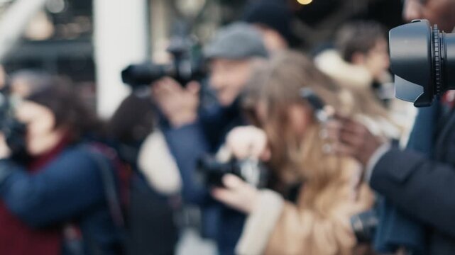 Paparazzi photographers taking pictures at a red carpet event