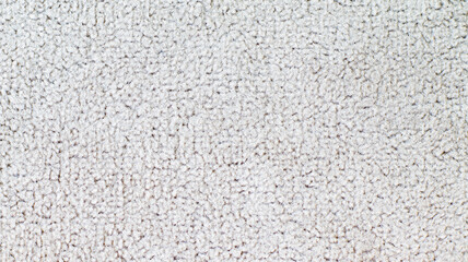 Premium light beige velour fabric texture with a soft fleecy surface. This high-quality textile material is perfect for interior upholstery, luxury fashion garments, and elegant backgrounds. © Александр Серебрянни