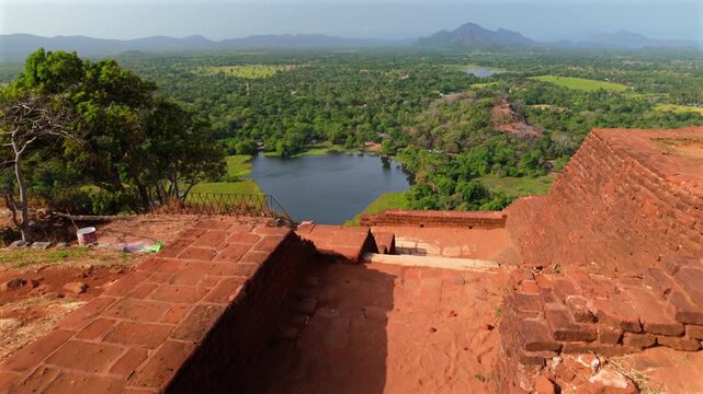 Ancient Brick Ruins Of Sigiriya Lion Rock In Sri Lanka, Overlooking Lush Green Forest And Calm Lake. high angle, POV shot