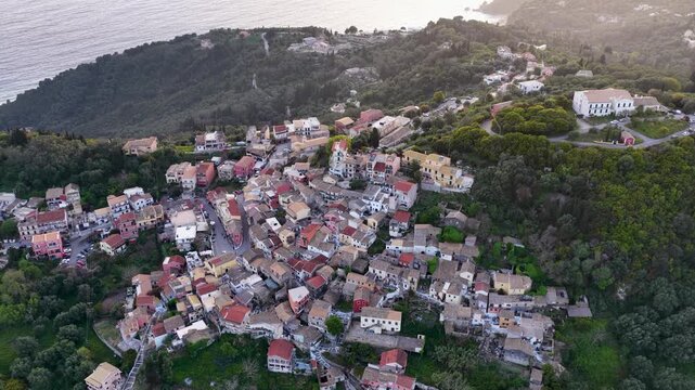 High Angle Drone View of Pelekas Village Roofs in Corfu, Greece. Authentic Traditional Greek Village Architecture Nestled in Green Hills by the Sea