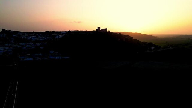 Stunning sunset over Obidos Castle, Portugal, silhouette against the sky