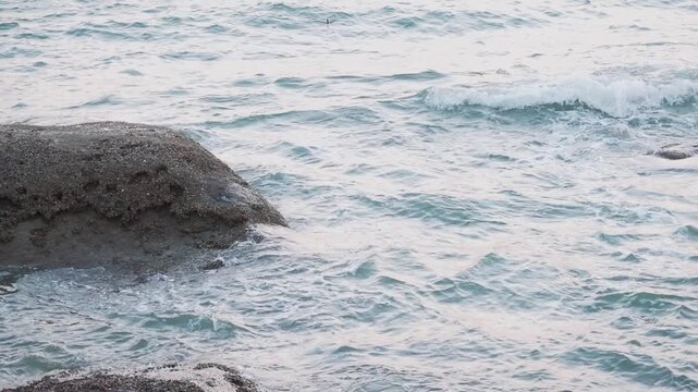Ocean waves move across a rocky shoreline