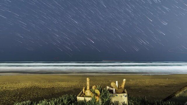 Long exposure nighttime timelapse featuring rotating star trails over the Atlantic Ocean and glowing Saint Augustine shoreline.
