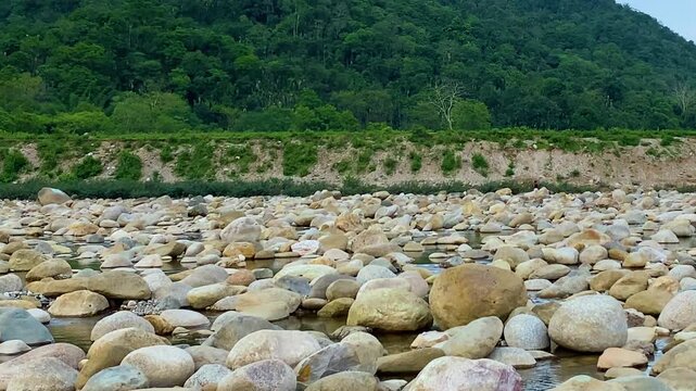 Beautiful rocky river with green hill and blue sky at Sylhet, Bangladesh.