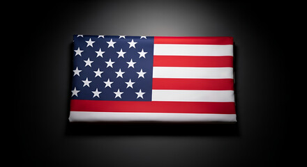 Fototapeta premium American flag on dark background with spotlight, patriotic symbol for Memorial Day, Veterans Day, and national pride, solemn United States banner for remembrance and honoring.
