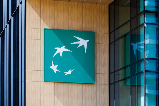 Warsaw, Poland &ndash; April 18, 2026: BNP Paribas logo on modern office building facade with glass and wood exterior in city center