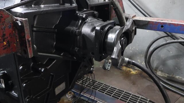 A professional view of an Allison transmission unit undergoing a spin test on a diagnostic rig to ensure performance and mechanical integrity.