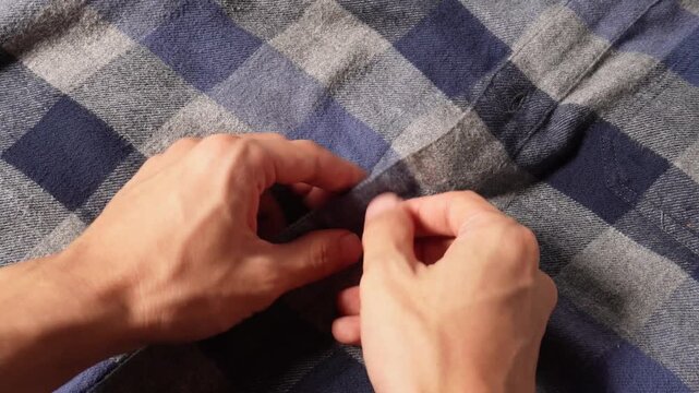 Hand buttoning flannel clothes