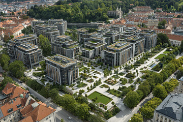 Fototapeta premium Modern urban housing complex with green rooftop gardens and tree lined streets surrounded by parks and traditional buildings, creating peaceful and eco friendly living environment
