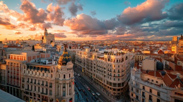 Aerial view of Madrid city center at sunset. Skyline with historic architecture and urban traffic on street. Travel destination and tourism concept. Spanish capital landscape urban scene.