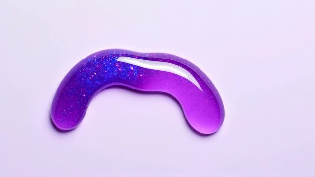 Gel-like crescent rests on plain background. Sparkling purple material with glittery texture. Shiny, glossy surface, macro shot, soft light. Relaxation tool, eye mask function. Concept of self-care