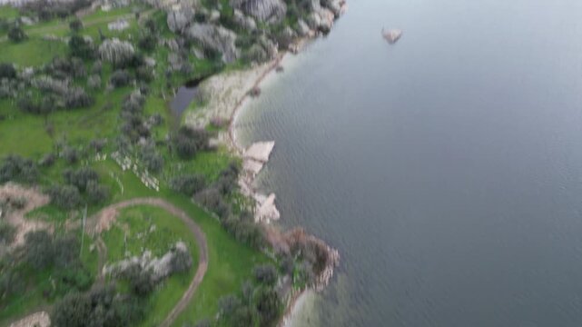 Drone footage captures the stunning natural beauty and historical significance of Bafa Lake Nature Park in Turkey. The aerial perspective showcases the serene waters of Bafa Lake nestled amidst rugged