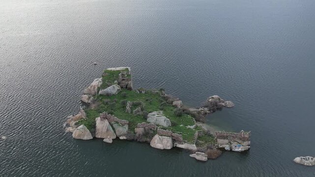 Drone footage captures the stunning natural beauty and historical significance of Bafa Lake Nature Park in Turkey. The aerial perspective showcases the serene waters of Bafa Lake nestled amidst rugged