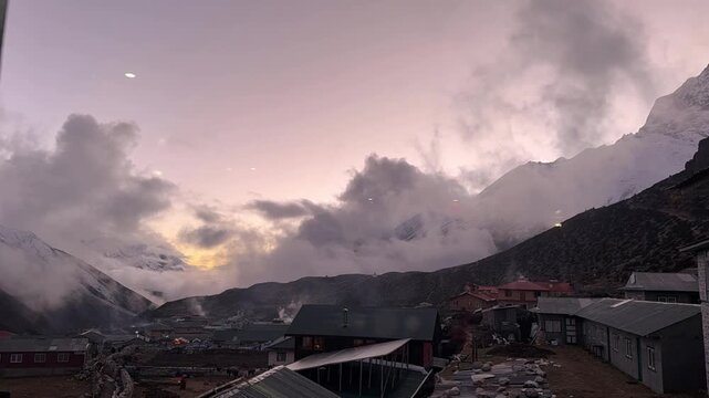 Timelapse of sunset over Dingboche village in the Himalayas on the Everest Base Camp trail, Nepal. Clouds moving over snowy peaks and mountain valley at high altitude