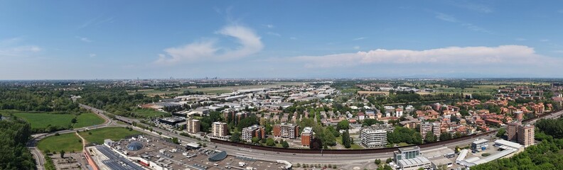 Obraz premium Aerial Cityscape Under Azure Skies: A panoramic aerial view showcases a sprawling urban landscape, Peschiera Borromeo, Milan, Italy, 