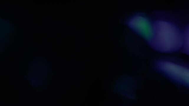 Real cool blue light leak sweeps across a dark background with organic optical glow. Practical light overlay for cinematic video transitions and motion background compositing.