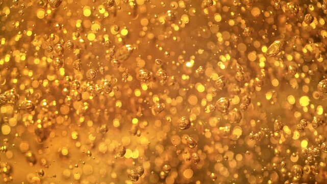 Super Slow Motion Shot of Flowing Golden Bubbles at 1000 fps.