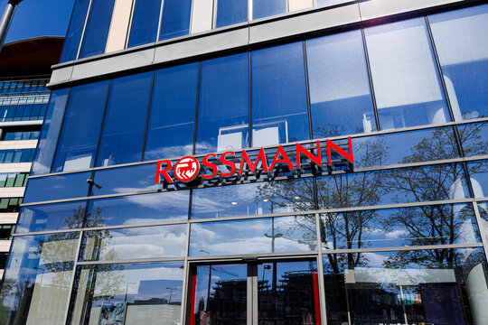 Warsaw, Poland &ndash; April 18, 2026: Rossmann storefront on modern glass building with reflections and entrance doors