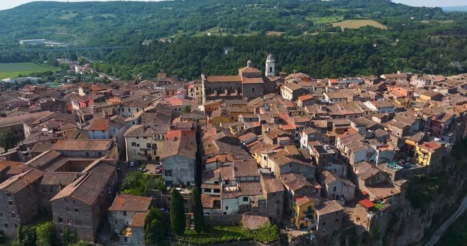 Detailed aerial drone view historic Santa Maria Assunta Cathedral in Orte Italy medieval architecture close up traditional stone facade summer travel destination Lazio region heritage.
