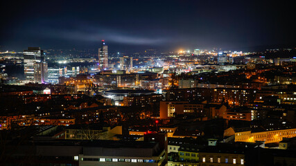Obraz premium Night photography of the city of Brno - Czech Republic - Europe. Landscape with buildings and lights in the evening. View of buildings in the city. AZ Tower the tallest building in the Czech Republic.