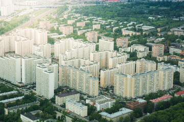Fototapeta premium Aerial view of residential apartment blocks surrounded by greenery. Urban housing development and real estate living concept with copy space.