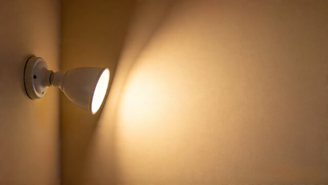 White wall sconce on beige wall