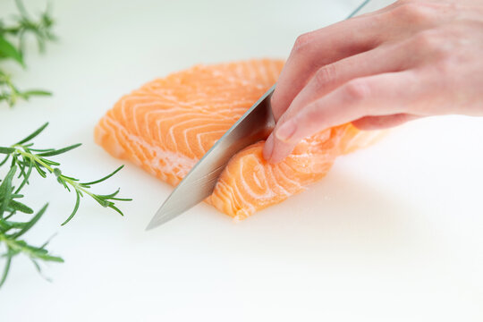 Cut the fresh raw salmon with a knife