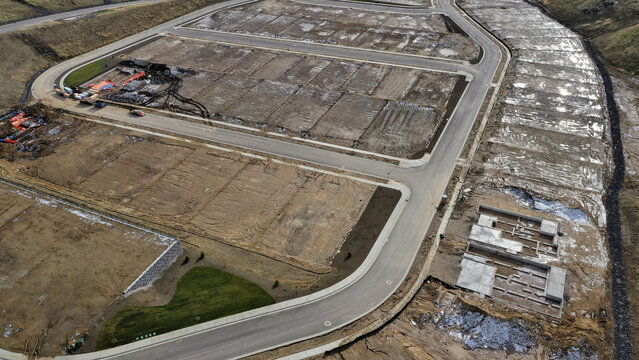 Overhead Aerial View of Brand New Residential Subdivision with Platted Lots and Road Infrastructure Under Early Construction