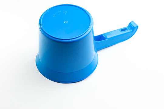 Blue plastic water dipper isolated on white background. Traditional bathroom scoop for water bailer