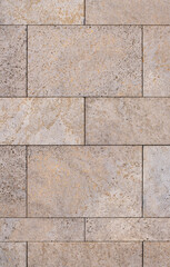 Fototapeta premium Natural stone tile wall facade with warm beige and orange mineral tones