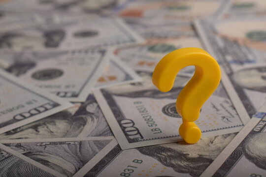 Question mark on US dollar bills background, symbolizing financial uncertainty, money decisions, investment risk, budgeting challenges, and economic problem concept.