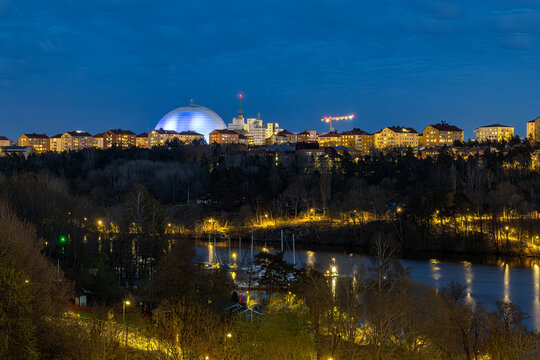 Stockholm, Sweden A night view of the Ericsson Globe Arena and Arstaviken Bay.
