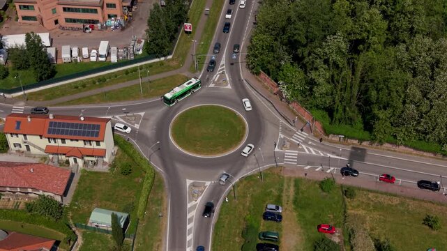 Roundabout Route and urban scene: Aerial view of a city roundabout, showcasing the smooth flow of traffic as it navigates the circular intersection.