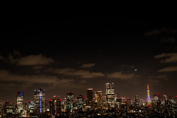 Fototapeta premium Skyscrapers of a Major City Illuminated by Various Lights at Night with Ample Copy Space in an Urban Business District