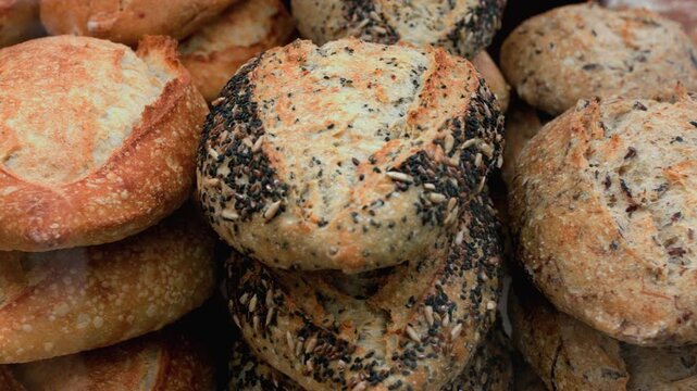 Displaying of freshly made tasty bread through bakery window in a supermarket. Close up.