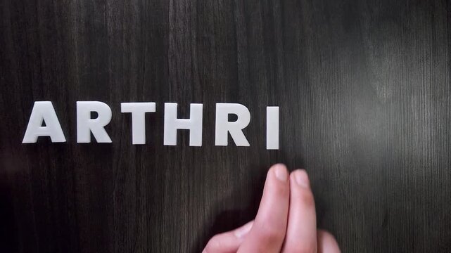the word arthritis written on a dark background with white block letters or capital letters (fast version)
