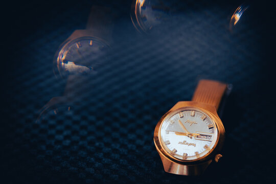Bucharest Romania 219April 2026. Close-up of a vintage Soviet-era Luch mechanical wristwatch featuring a classic gold-tone case and metal bracelet. blue background