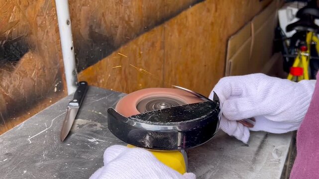Man testing sharpness of knife after sharpening process
