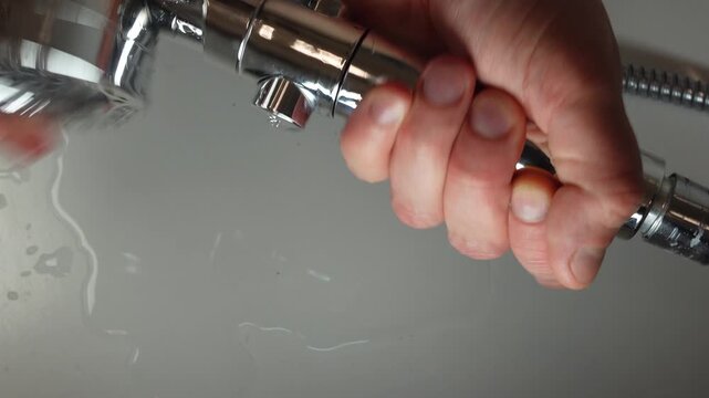 Hands replacing filter inside shower head. Bathroom maintenance