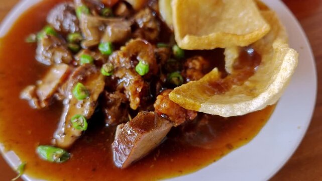 Siobak Babi Singaraja Traditional Balinese Pork Dish with Savory Gravy and Rice Crackers