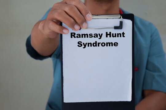 Doctor holds in hands a clipboard with the name of the Ramsay hunt syndrome. Medical concept