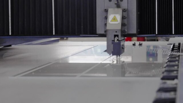 The machine is notching aluminum composite panels in the factory.