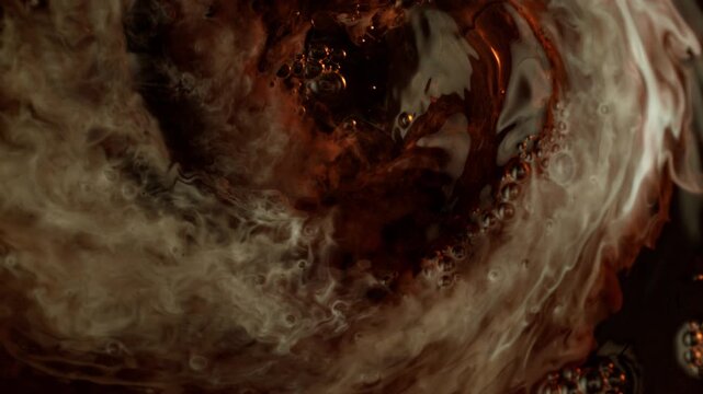 Super Slow Motion Shot of Swirling Cream Mixing in Coffee with Ice Cubes at 1000fps.