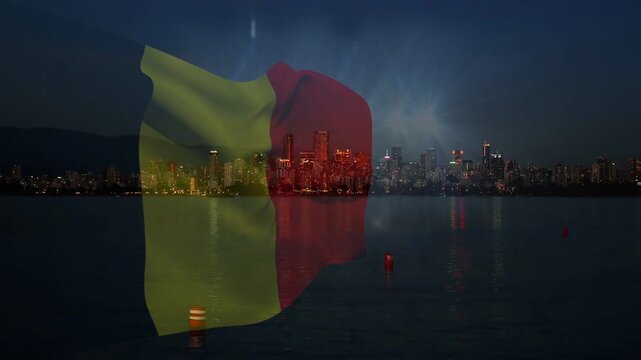 Translucent vertical flag unfurling and fluttering as night breeze starts, revealing skyline lights