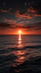 Fototapeta premium Ocean sunset with vibrant orange and red colors reflecting on the water