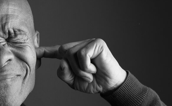 Deaf individual using sign language to communicate, on dark background stock image stock photo