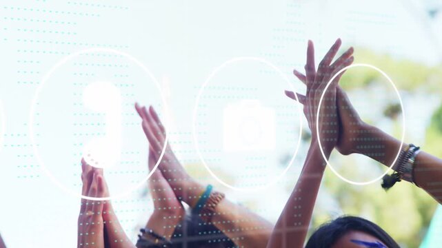 Social friends raising arms, clapping and celebrating outdoors, causing UI icons overlaying hands