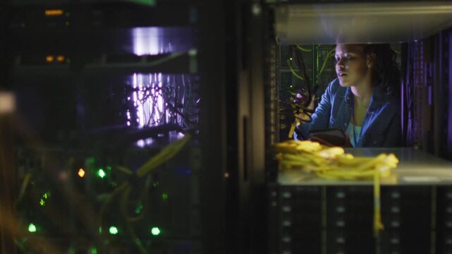 Woman technician starting handheld scan in rack aisle checking cables overlay rising verifying link