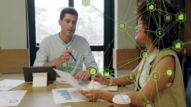 Woman placing report man reading charts in business green overlay animating over woman for analysis