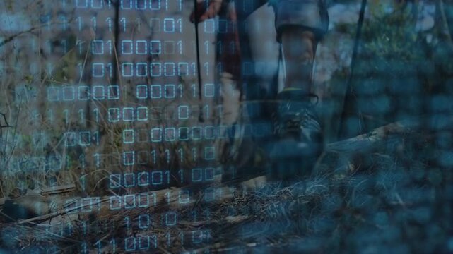Pair of hikers using poles and stepping initiating low camera follow tech binary overlay over boots